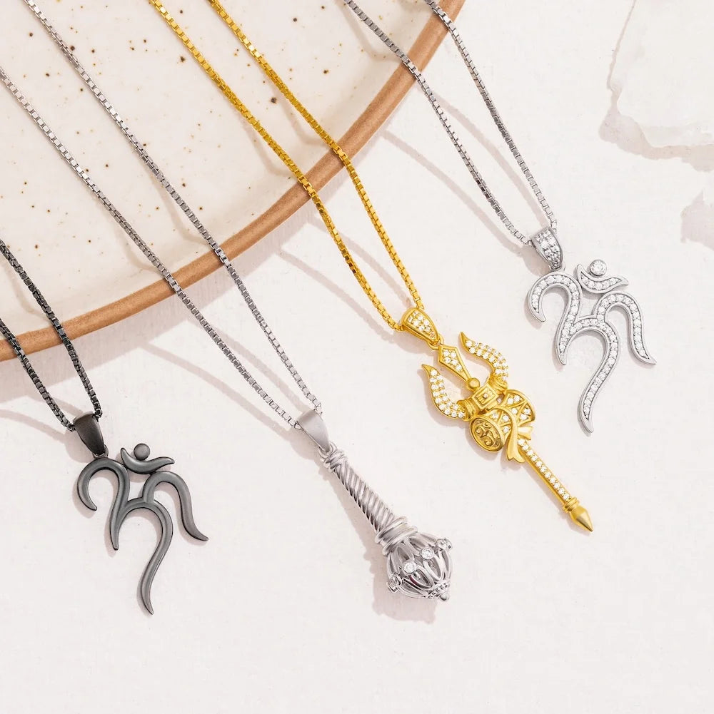 Four orionz necklaces with unique pendants on a light background