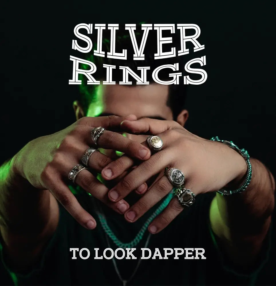 A person showcasing multiple silver rings on fingers, wearing jewelry to enhance a stylish, edgy look, with bold textSilver Rings