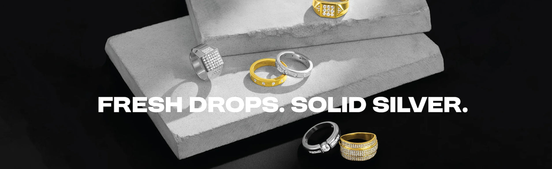 Silver rings displayed on a black background with text 'Fresh Drops. Solid Silver.'