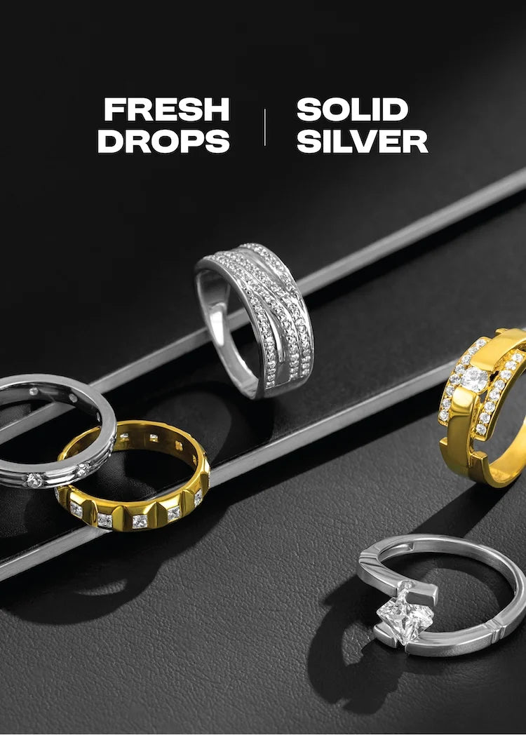 Gold and silver rings on a black surface with 'Fresh Drops' and 'Solid Silver' text.