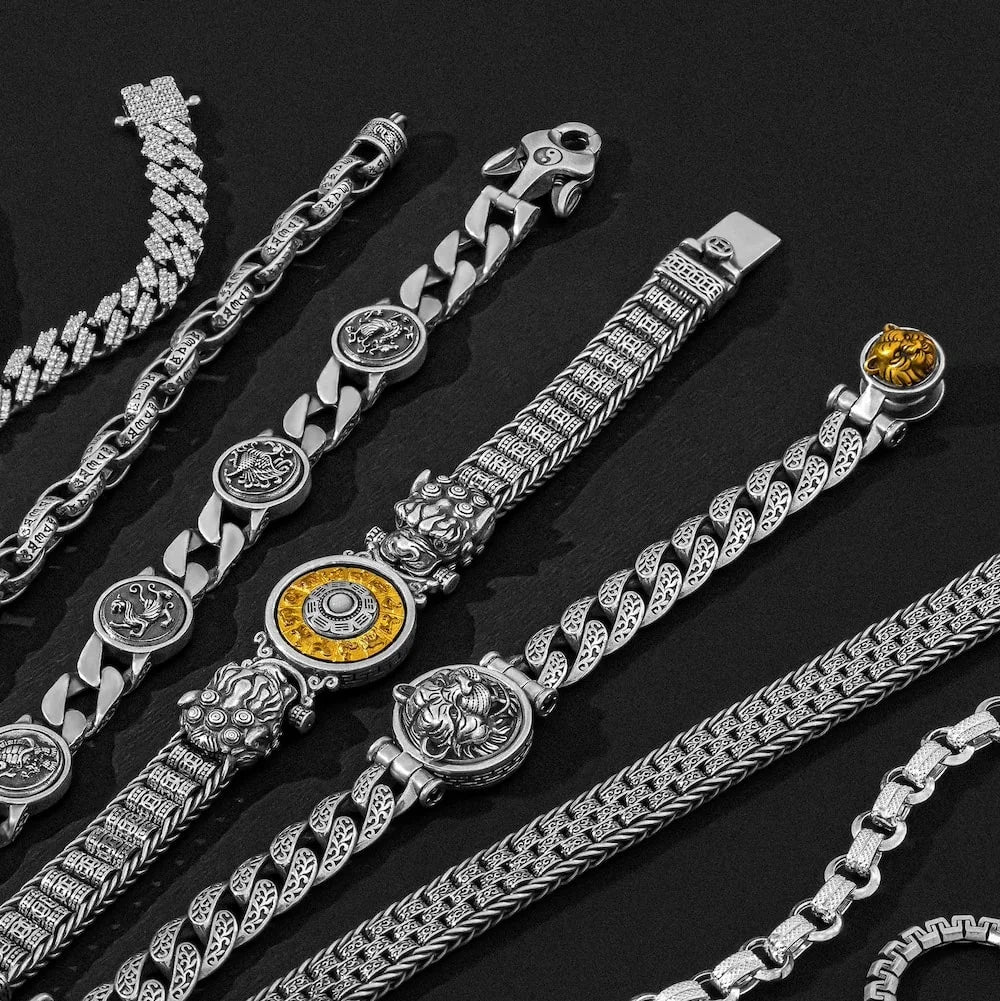 Collection of silver and gold orionz bracelets on a dark background