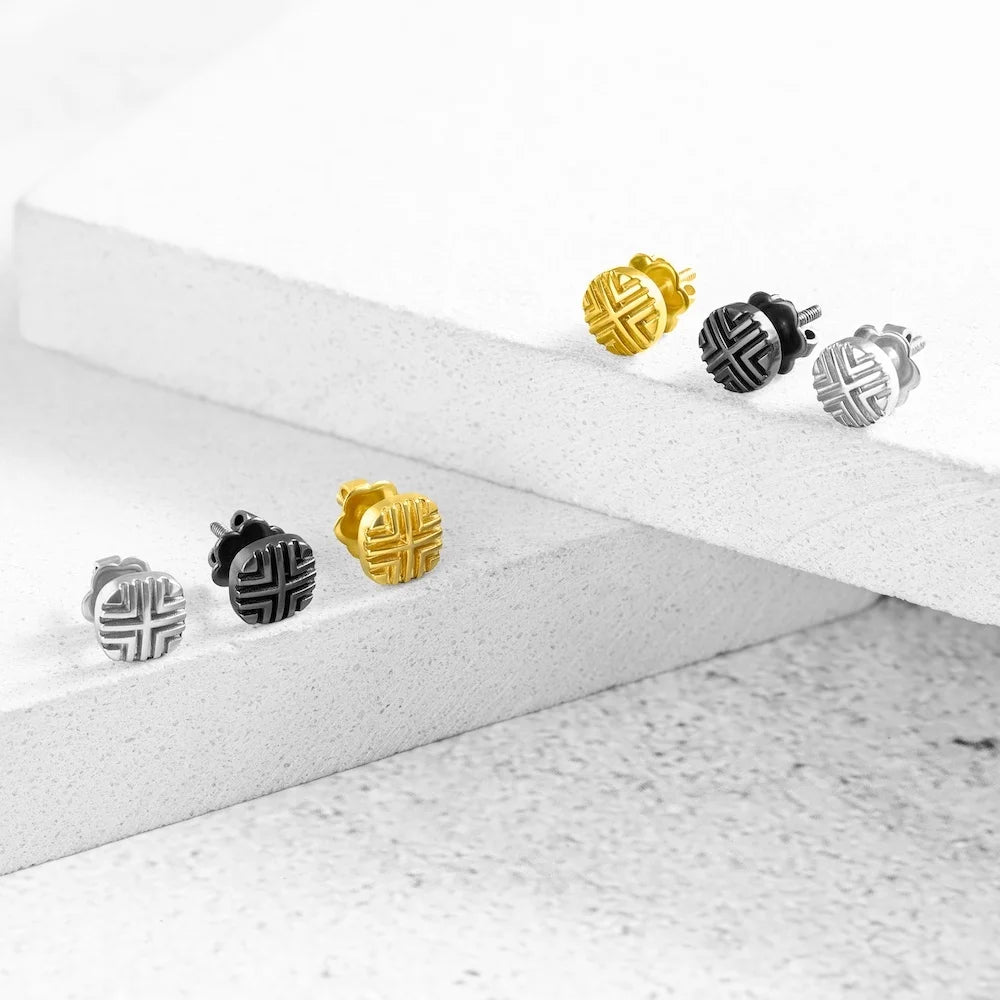 Set of orionz gold, silver, and black earrings on a white surface